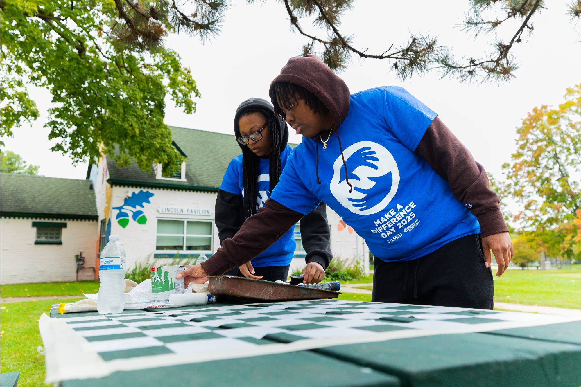 2 people painting table